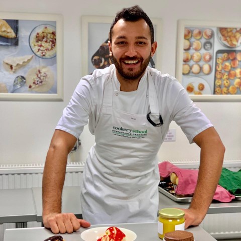 Faraj smiling in his chef's apron